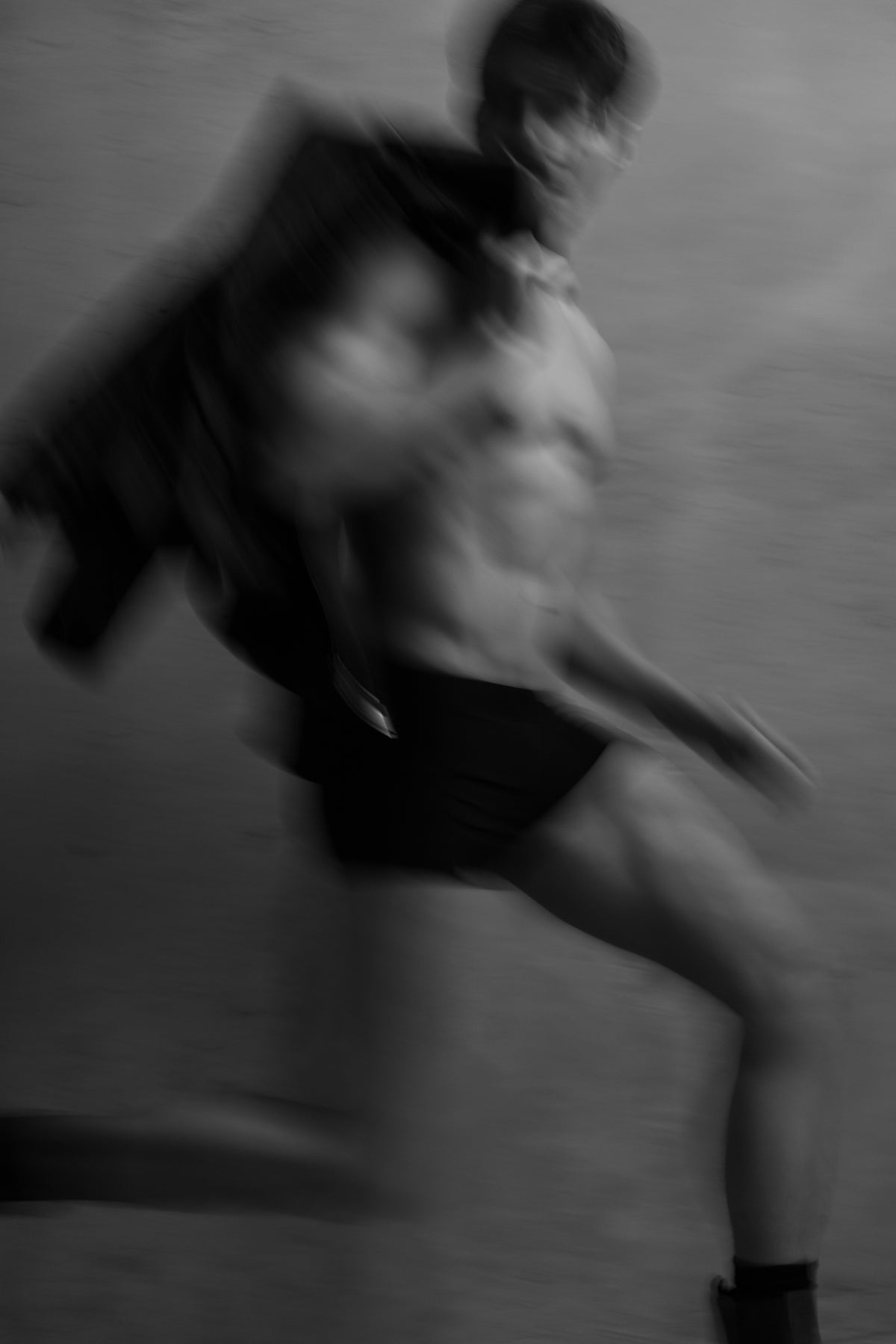 Schwarz-Weiß-Aufnahme eines Mannes in schwarzen Boxer Trunks in Bewegung